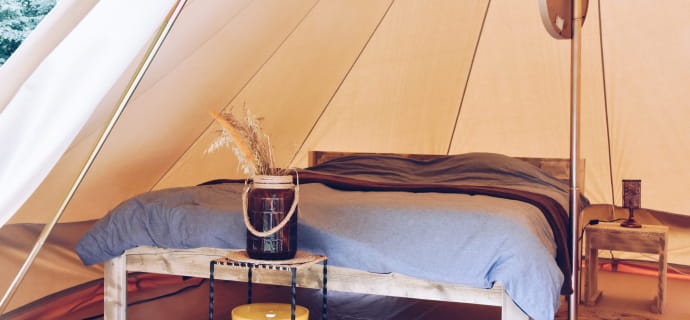 Bed inside a comfortable bell tent at Domaine d'Haulmé